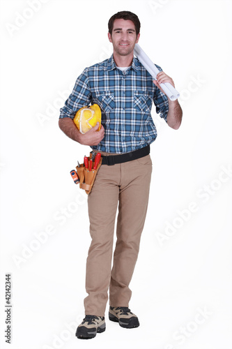 Foto: Tradesman holding rolled-up drawings, tools and equipment Tradesman holding rolled-up drawings, tools and equipment