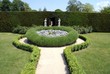 decorative gate &  path with statues and hedges