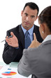 Photo: businessman and businesswoman having a discussion businessman and businesswoman having a discussion