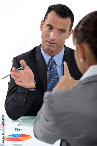 Photo: businessman and businesswoman having a discussion businessman and businesswoman having a discussion