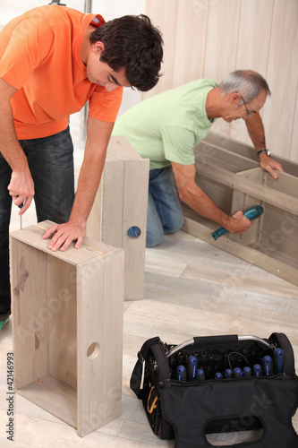 Photo: Grandfather and grandson assembling furniture Grandfather and grandson assembling furniture