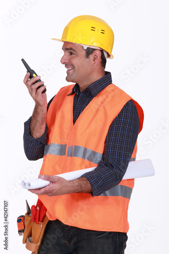 Photo: Happy architect communicating via radio Happy architect communicating via radio