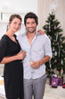 Couple in front of a Christmas tree
