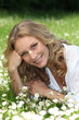 Woman lying in the daisies