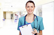 Smiling female medical doctor with clipboard
