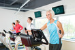 Photo: Young people on fitness treadmill running exercise Young people on fitness treadmill running exercise