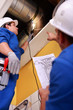 Two workers inspecting ventilation system