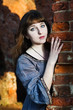 Photo: Young beautiful woman near brick wall Young beautiful woman near brick wall