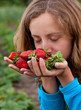 Young woman with red fresh strawberries in hands