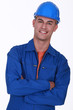 smiling construction worker with folded arms