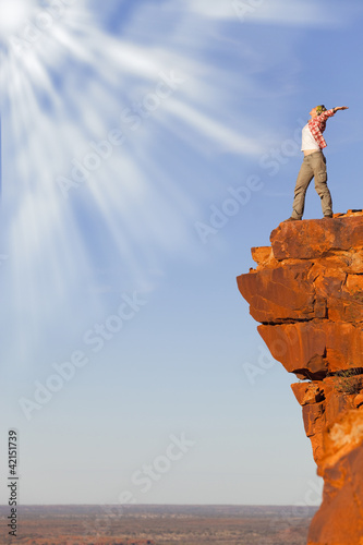 Photo: freedom woman on the rock looking to the sun freedom woman on the rock looking to the sun