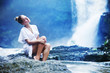 Young woman near waterfall, bali, indonesia
