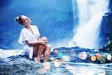 Young woman near waterfall, bali, indonesia