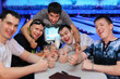 Foto: Five happy friends sit at table and thumb up in bowling; Five happy friends sit at table and thumb up in bowling;