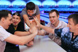 Foto: Five happy men sit at table and touch hands in bowling; focus on Five happy men sit at table and touch hands in bowling; focus on