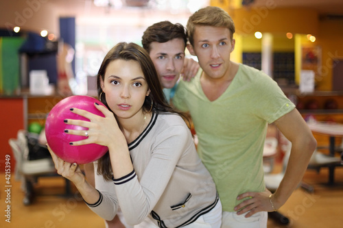 Photo: Woman prepares to throw of pink ball in bowling; Woman prepares to throw of pink ball in bowling;