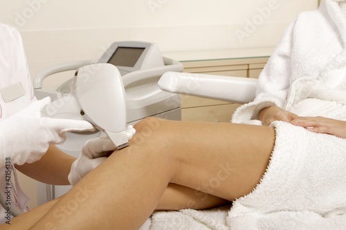 Photo: Young woman receiving laser therapy Young woman receiving laser therapy