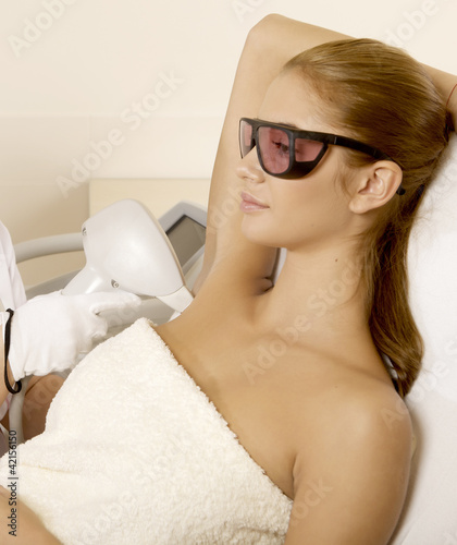 Photo: Young woman receiving laser therapy Young woman receiving laser therapy