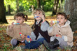 Young children blowing bubbles in the woods
