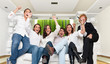 Family in modern interior watching a winning match