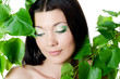 Photo: Beautiful woman with spring green leaves Beautiful woman with spring green leaves