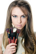 The beautiful girl with brushes for a make-up