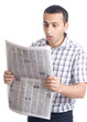 Photo: Young man reading newspaper Young man reading newspaper