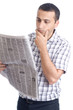 Photo: Young man reading newspaper Young man reading newspaper