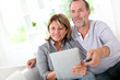 Senior married couple choosing movie on tv
