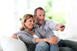 Senior couple watching television at home