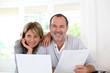 Senior couple at home declaring income on internet