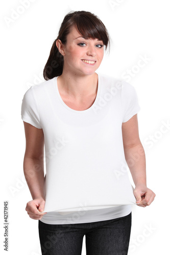 Photo: Attractive young girl trying on a shirt Attractive young girl trying on a shirt