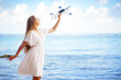 young woman with toy airplane