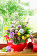 red teapot with bouquet of healing herbs and flowers on windowsi