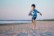 Kid Runs On The Beach at sunset