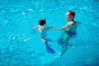 Father teaching his little son to swim