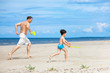 Father and son playing on the beach