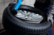 Tire change closeup, mechanic at work