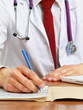 Hands of a doctor filling RX prescription, documents at the desk