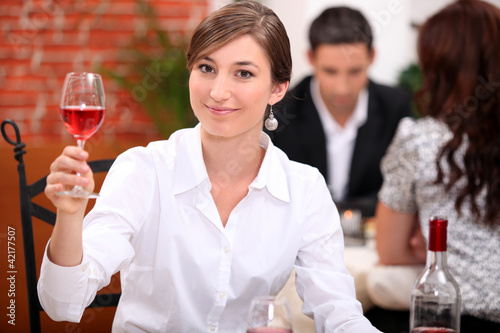 Photo: Young woman appreciating a glass of rose wine Young woman appreciating a glass of rose wine
