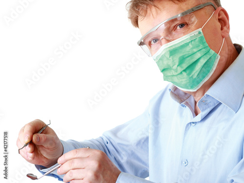 Photo: Dentist with tools, isolated on white background Dentist with tools, isolated on white background