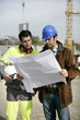 construction site supervisors looking at a blueprint