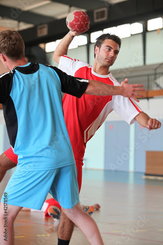 Photo: Man throwing ball during handball game Man throwing ball during handball game