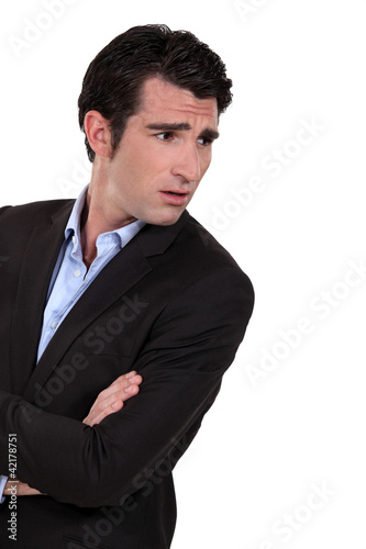 Photo: Businessman with his arms folded in disbelief Businessman with his arms folded in disbelief