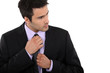 Businessman adjusting his tie