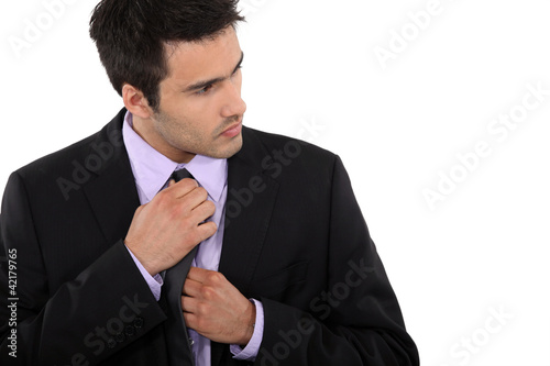 Photo: Businessman adjusting his tie Businessman adjusting his tie