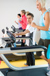 Young fitness instructor woman running at gym