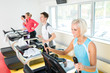 Photo: Young people on fitness treadmill running exercise Young people on fitness treadmill running exercise