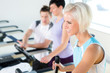 Photo: Fitness young people on treadmill cardio workout Fitness young people on treadmill cardio workout