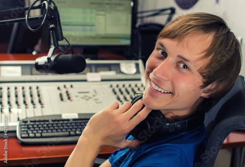 Photo: Dj in front of a microphone on the radio Dj in front of a microphone on the radio